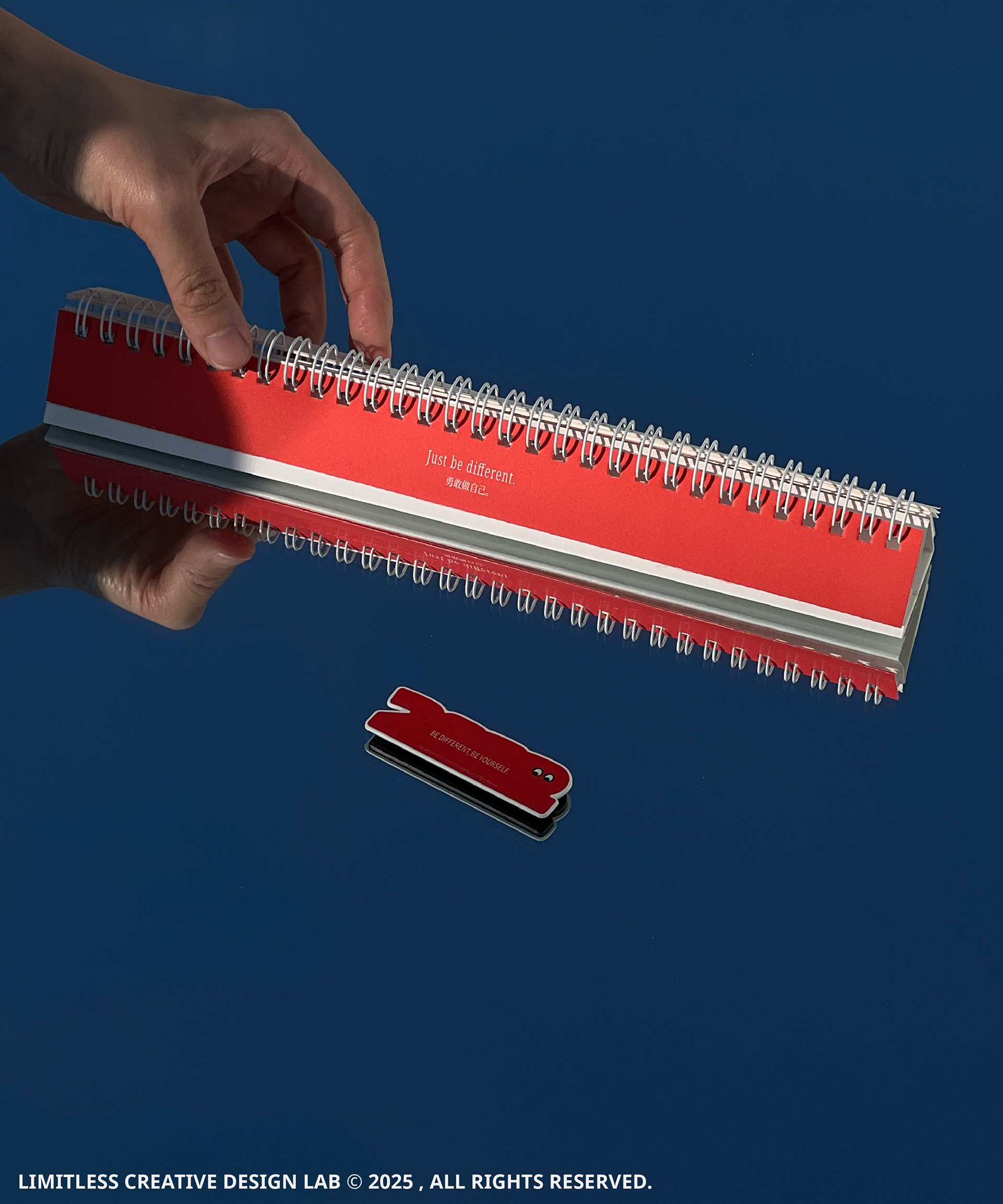 The red cover and spiral binding of the Be Different calendar.