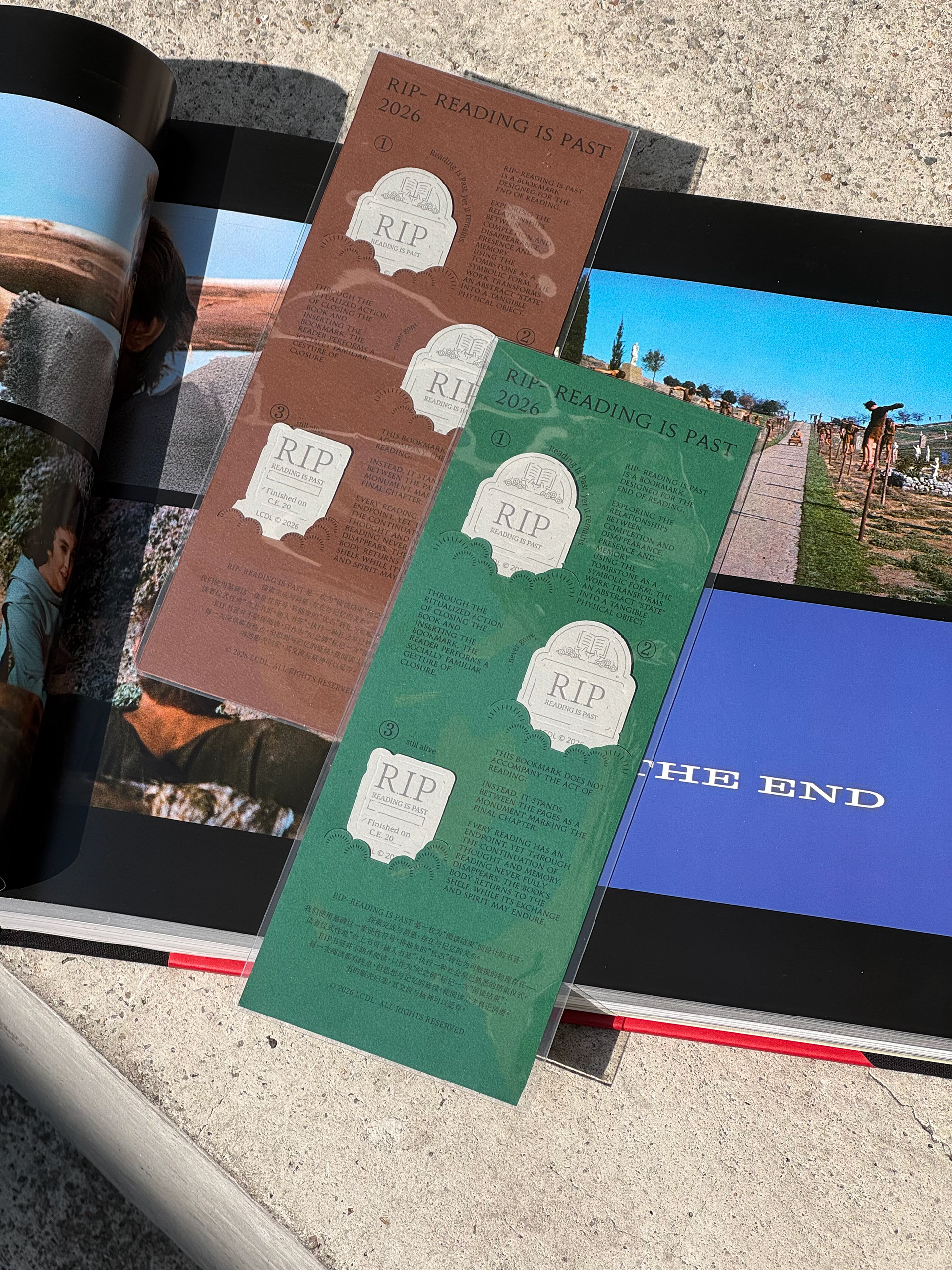 Green and brown printed cards from the RIP bookmark project, arranged over open book pages.