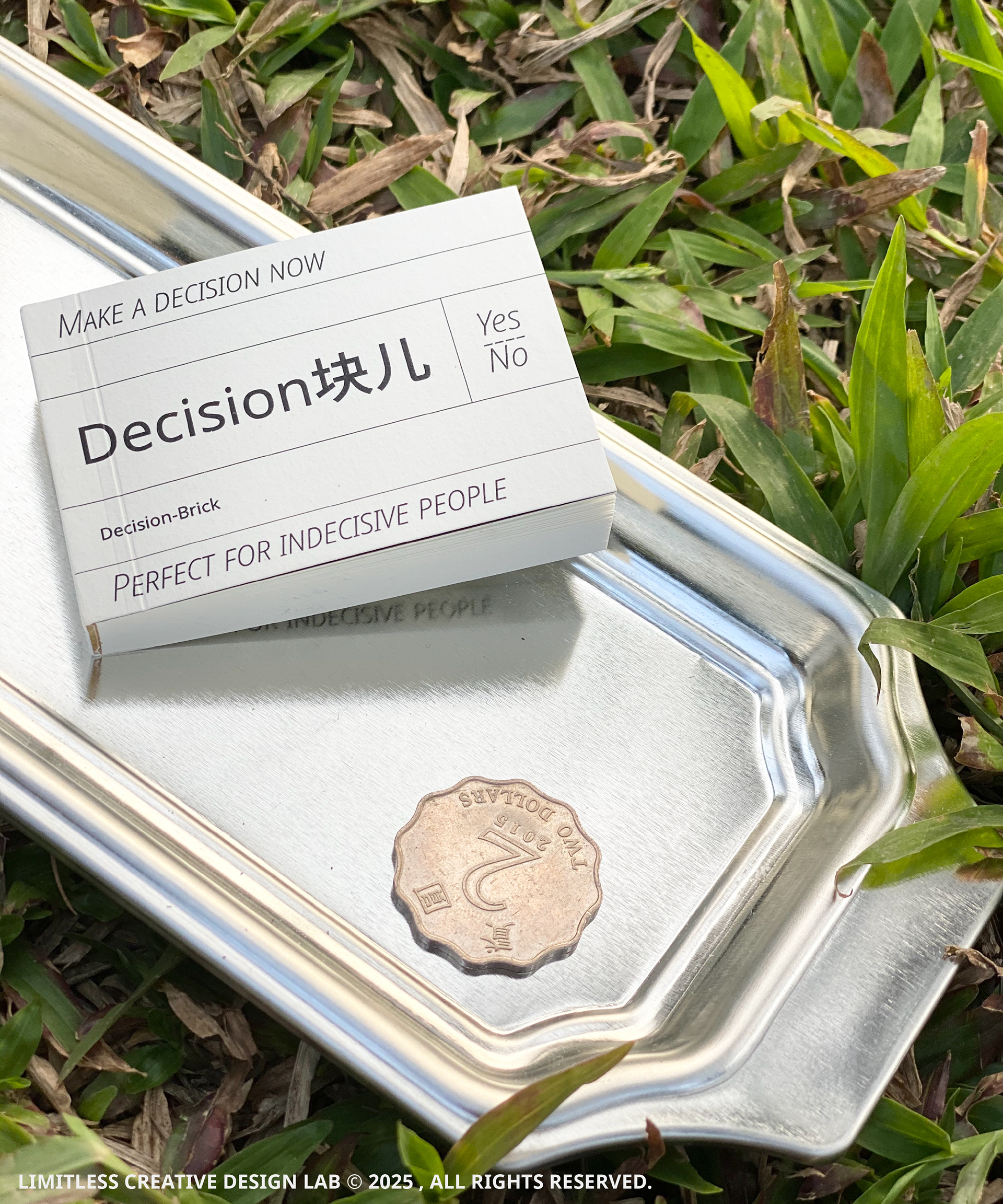 The Decision Block cover and a coin on a metal tray outdoors.