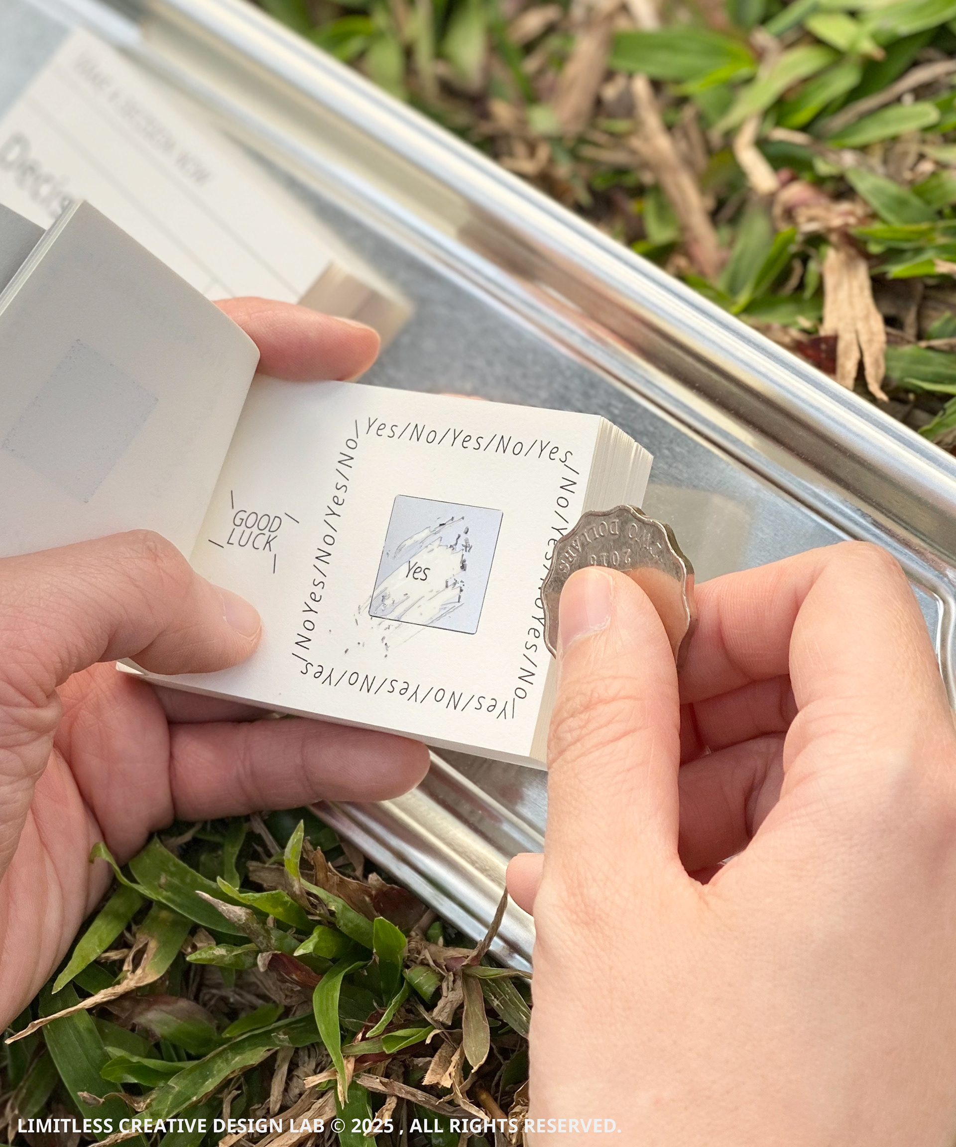 A hand using a coin to scratch a panel inside The Decision Block.