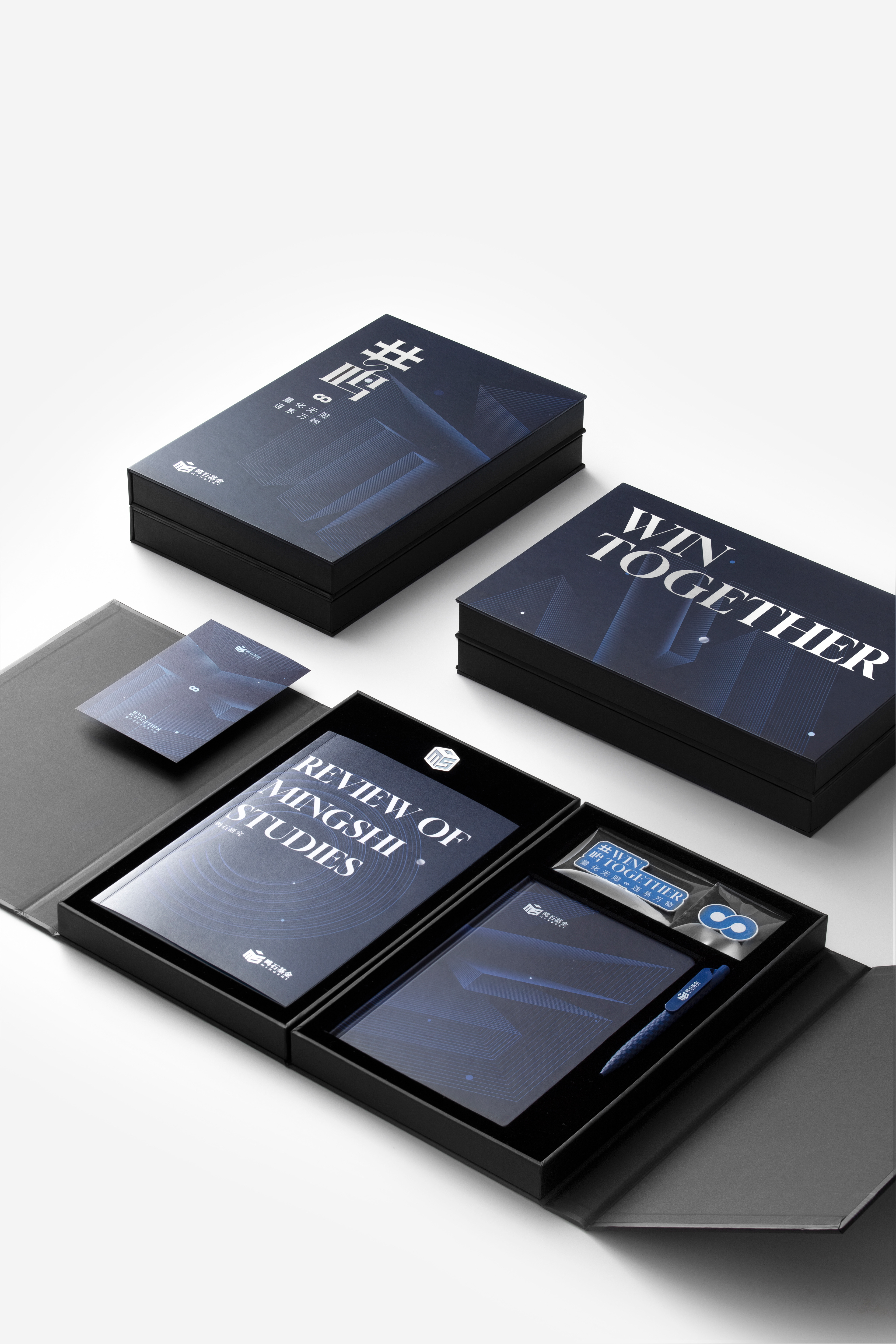 An open Win Together gift box showing a notebook and its compartment layout.